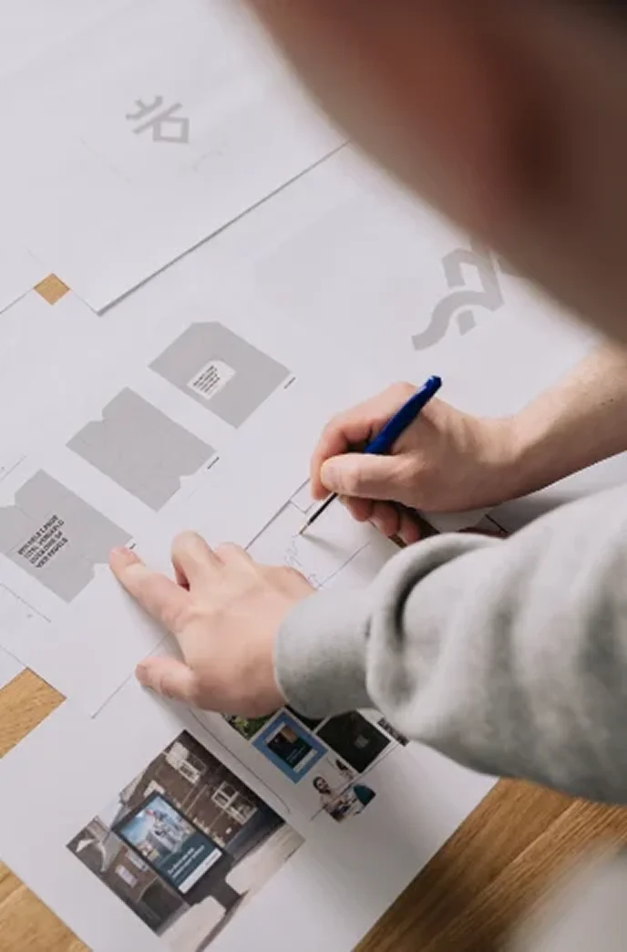Vincent van Brandbits sketches on printed logo and brand concepts with a pen.