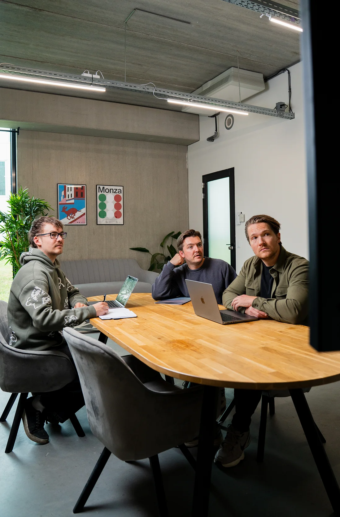 Three team members from BRANDBITS are discussing an employer branding strategy together.